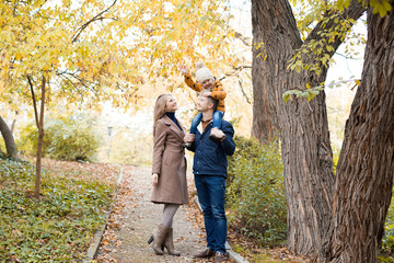 family to boys walk on autumn Woods