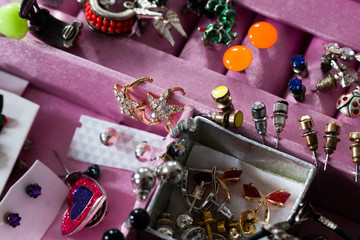  pink tealight jewelry box with colorful earrings, brooches and other trinkets