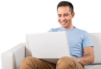 Smiling Man Using Laptop while Sitting on a Couch