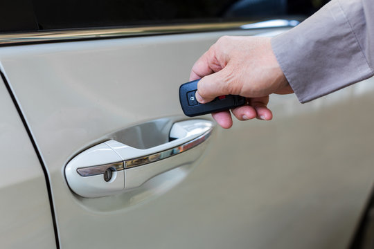 Male Hand Open The White Car With Keyless Entry Function