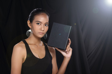 Your different text here. Pretty young asian model face woman holding empty blank board black box © Jade