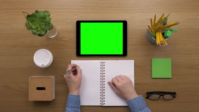 Overhead Top View Of Woman Preparing To-Do List In Notebook