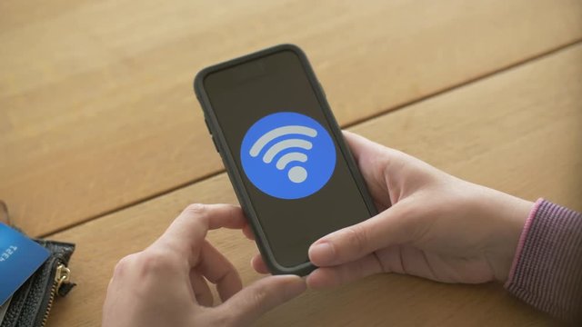 Woman Holding Credit Card And Smartphone With Wifi Icon