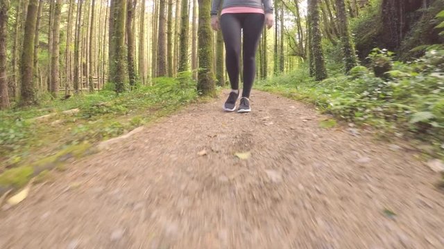 Tracking Shot Of Fit Female Athlete Walking On Forest Trail