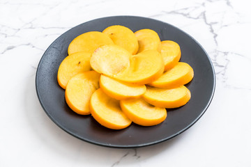 sliced persimmon on plate