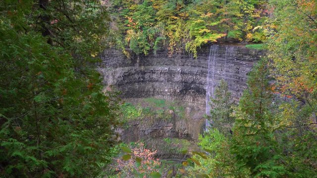 The amazing 41 metre ribbon waterfall, Tew's falls found in Hamilton, Ontario, Canada. Handheld tilt up establishing shot in 4K with sound.