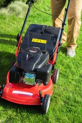 Closeup of a Gardener Using a Lawn Mower