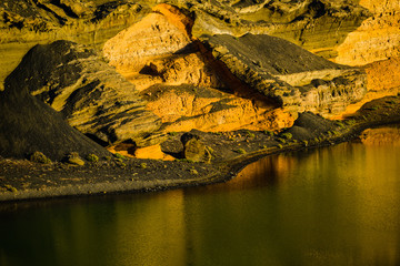 Incredible view of the volcanic green lake (El Lago Verde, Charco de los Clicos) in El Golfo. Lanzarote. Canary Islands. Spain