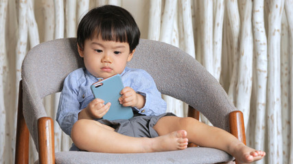 Young little boy using smart phone