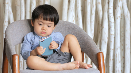 Baby boy holding mobile phone