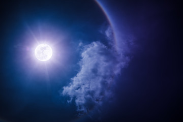 Naklejka na ściany i meble Moon halo phenomenon. Nighttime sky and bright full moon with shiny.