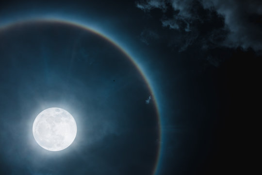 Moon halo phenomenon. Nighttime sky and bright full moon with shiny.