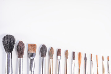 Set of paint brush on white background. Different models of brushes for painting isolated. A place for your inscriptions. Background for a site design or landing page about art and drawing. Flat lay