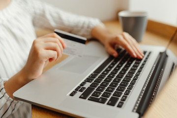 Woman with laptop shopping online. Payment Transaction at Computer using Credit Card