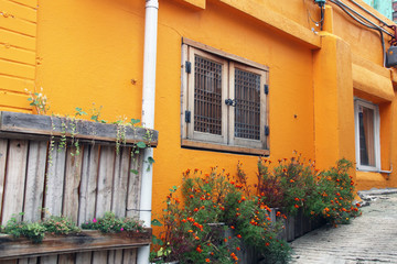Fototapeta na wymiar Orange color wall has a window