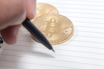 hand writing on notebook and bitcoin