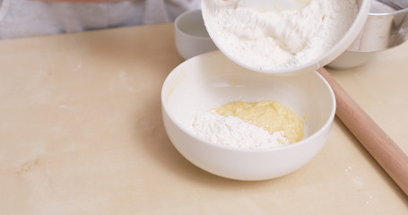 Fototapeta na wymiar Stirring powder and dough at home