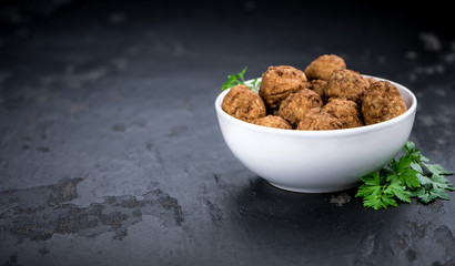 Fresh made Meatballs on a slate slab (close-up shot; selective focus)