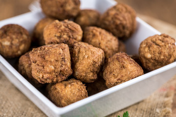 Meatballs on an old wooden table (selective focus)
