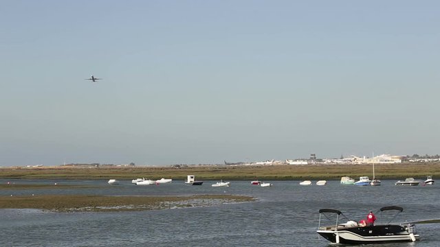 Takeoff of the plane over Ria Formosa in the city of Faro. Portugal
