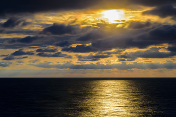 Fototapeta premium Stylized abstract landscape seascape sunset long exposure with clouds under different shades of blue, orange, yellow and red.