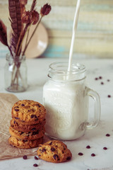 Milk in a glass and cookies with chocolate
