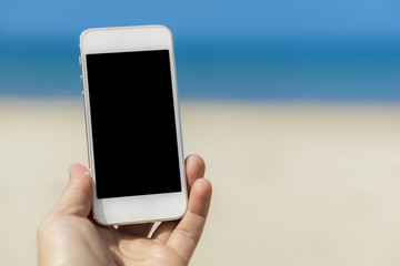 Man hand holding the white smartphone