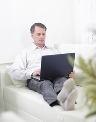 businessman working on laptop while sitting in a hotel room