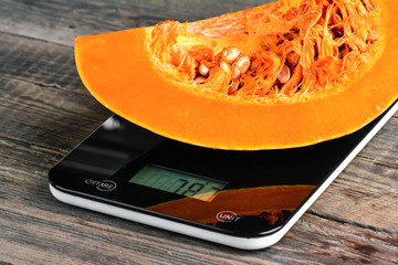 Cut pumpkin on the scales