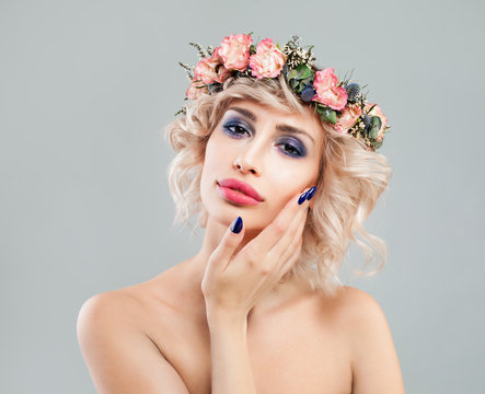 Beautiful Blonde Lady with Flowers on Hair touching her Hand Her Face