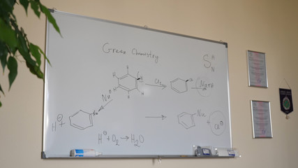 Hand-drawing chemical formulas. Organic chemical formulas on a white chalkboard. Blackboard with chemical formulas
