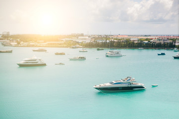 Obraz premium Tropical islands and atolls in Maldives in Indian Ocean from aerial view. Boats on the water. Piece of paradise on the Earth. Good choice for vacation. Beautiful top view for wallpaper.