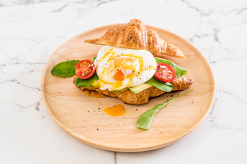 egg benedict with avocado, tomatoes and salad