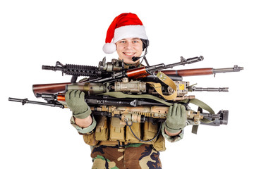 soldier with rifle wearing Santa claus cup and holding cardbox isolated on white background