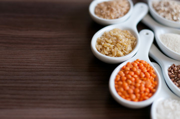 Cereals in a white dish on a dark wooden background. Close-up with soft focus.