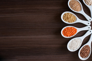 Cereals in a white dish on a dark wooden background. Close-up with soft focus.