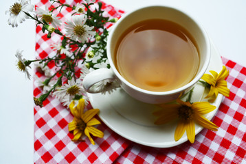 Cup of tea with herbs and vitamins on the table