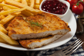 Chicken schnitzel, served with fries and salad.