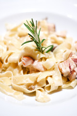 pasta with champignons, chicken and sauce and thyme on white background. .