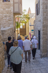 Obraz na płótnie Canvas JAFFA, ISRAEL- OCTOBER16, 2017: Tourists and travelers to the stone streets of the ancient city of Jaffa, Israel