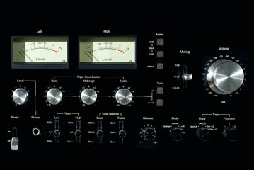 Obraz premium Front panel section of audio power amplifier with switches and knobs