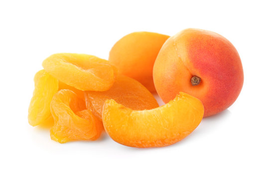 Dried and fresh apricots on white background