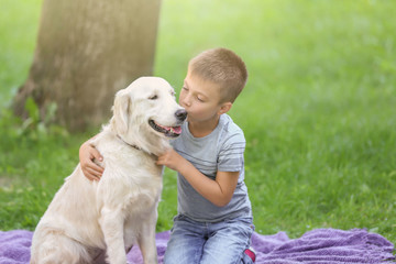 Cute little boy with dog in park