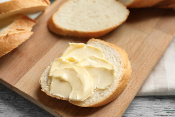 Fototapeta na wymiar Slice of bread with butter on wooden board