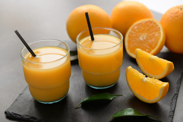 Glasses of fresh orange juice on slate plate