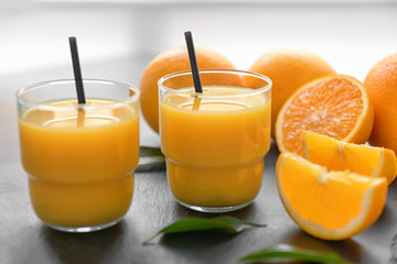 Glasses of fresh orange juice on slate plate