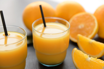 Glasses of fresh orange juice on slate plate