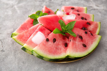 Plate with tasty sliced watermelon on table