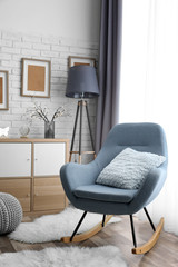 Living room interior with grey rocking chair and pillow