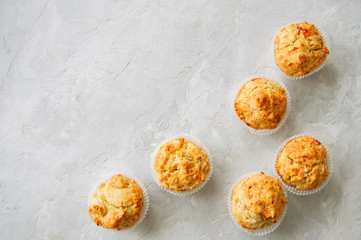 Homemade savory muffins with fish and cheese on a white stone background. Healthy snack or breakfast meal.